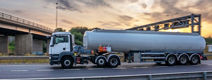 large semi truck pulling tank down highway