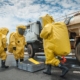 Image of people wearing hazmat suits testing a tanker truck