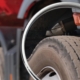 View of commercial truck tires in a rearview mirror