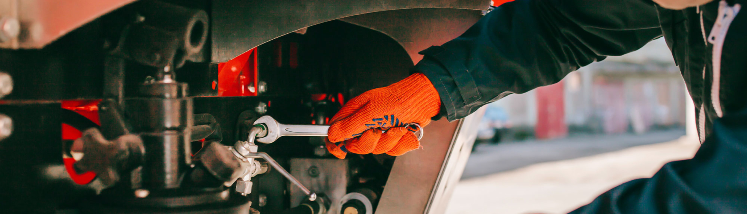 Mechanic wrenching a truck