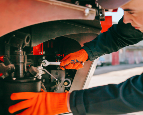 Mechanic wrenching a truck