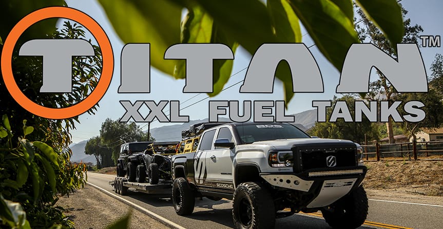 Titan Fuel Tanks logo over a customized truck hauling other vehicles