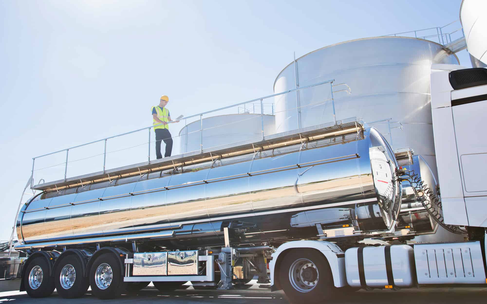 Worker-on-platform-above-stainless-steel