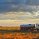 Truck driving on a road at sunset