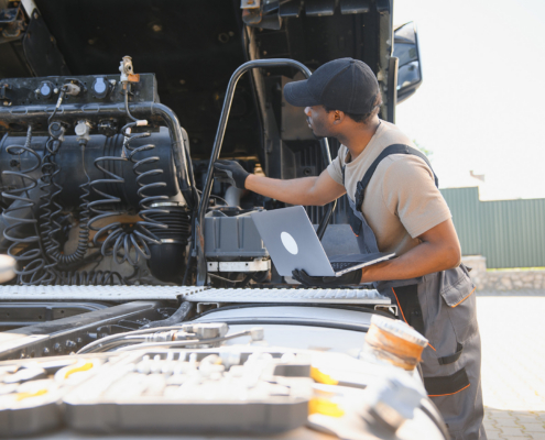 Truck repair service. Mechanic makes computer diagnostic of the semitruck